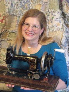 Pami Woodruff holding antique sewing machine