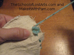 Thread pulled most of the way through.